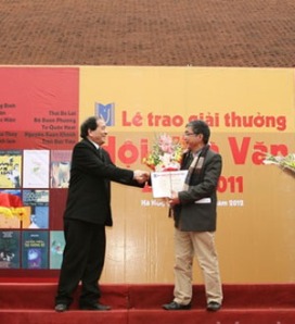 Nhà thơ Hữu Thỉnh trao giải thưởng cho nhà văn Trung Trung Đỉnh. Ảnh: VanVN
